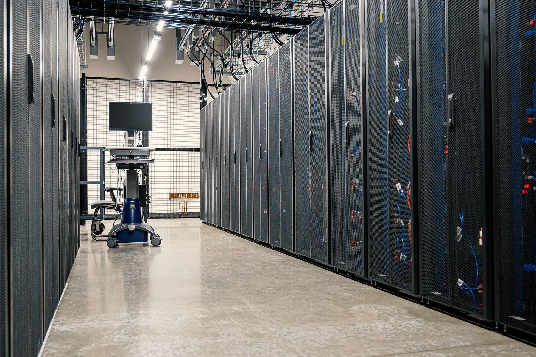 Server racks in a managed data center, cabled and running